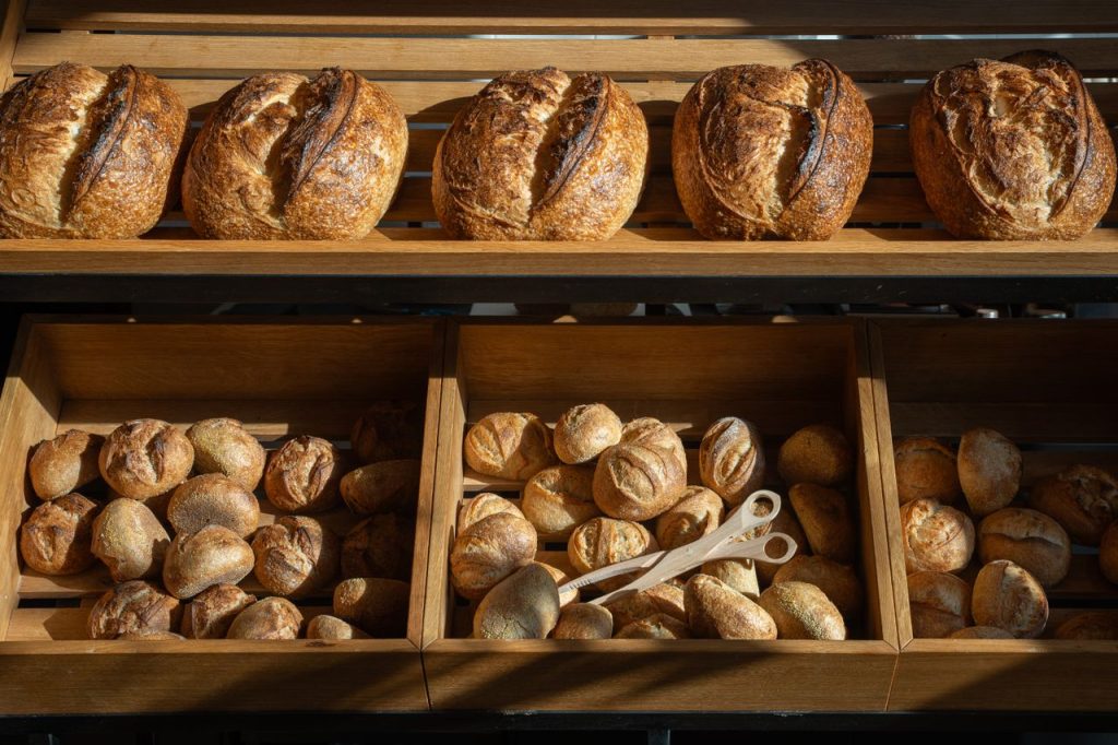 Freshly baked artisan breads displayed in a Berlin bakery, emphasizing variety and craftsmanship.
